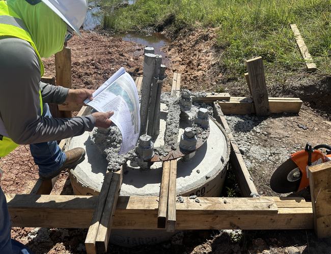 Checking plans on an anchor bolt foundation